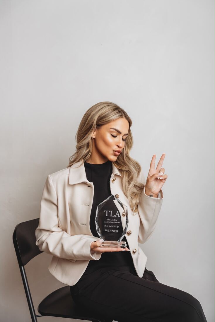 Jade Peel holding her Best Natural Lips trophy from The Leading Aesthetics Awards